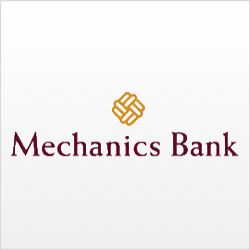 In the image, mechanics are working on a car at a bank. Full Text: Mechanics Bank