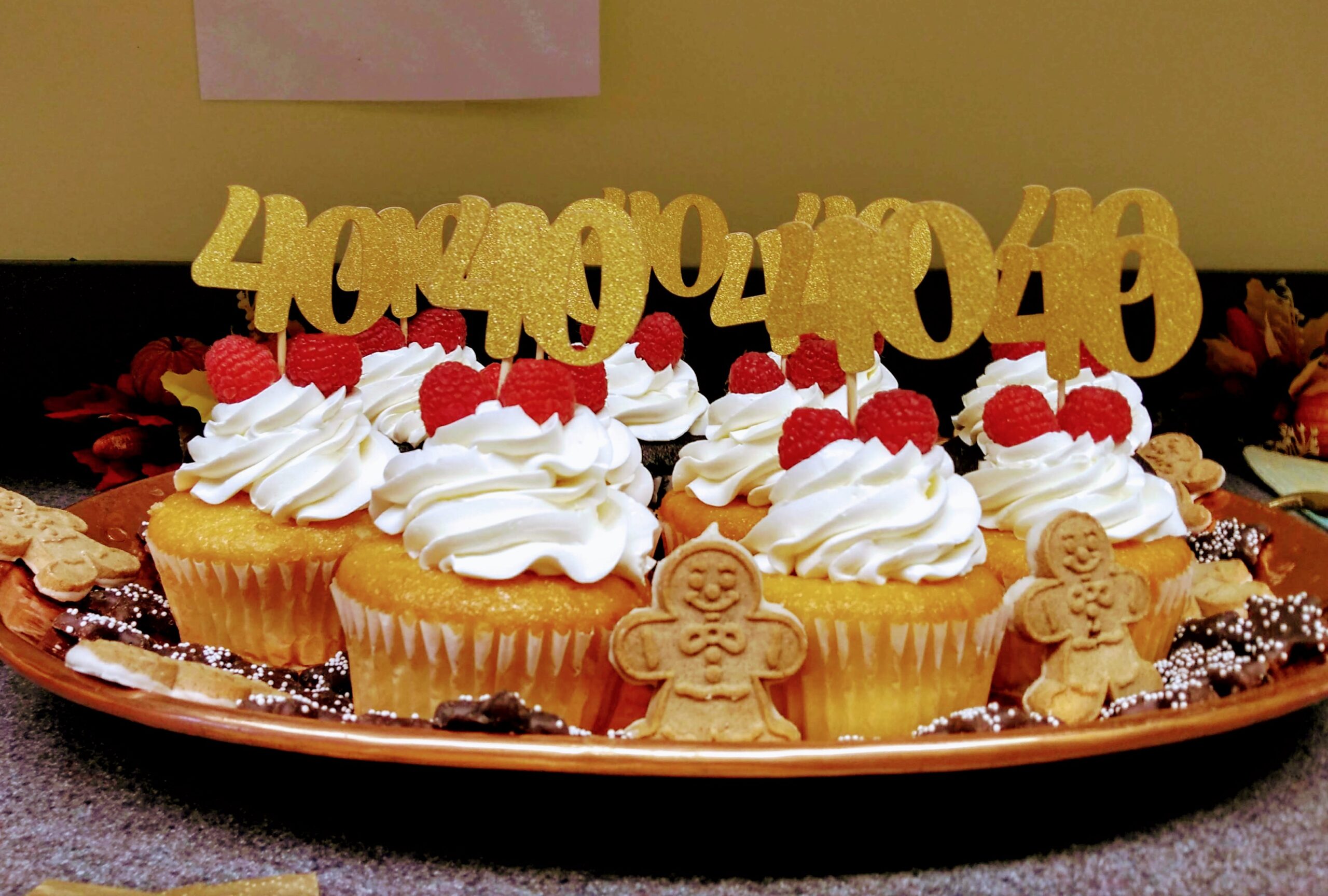 A plate of cupcakes is present.